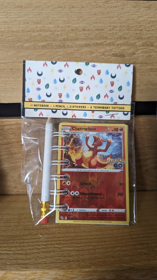 Pokémon card notebooks are packaged with a pencil, two random stickers, and two random temporary tattoos.