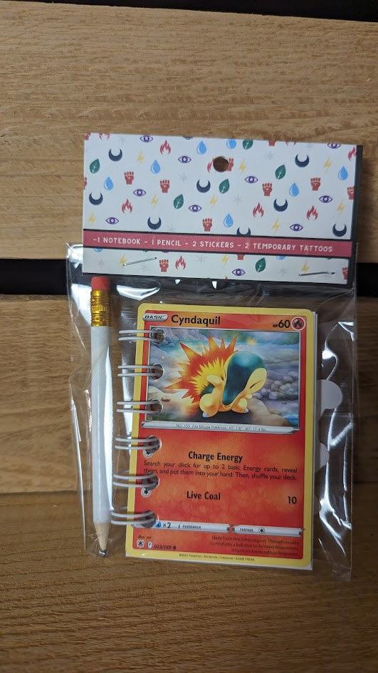 Pokémon card notebooks are packaged with a pencil, two random stickers, and two random temporary tattoos.