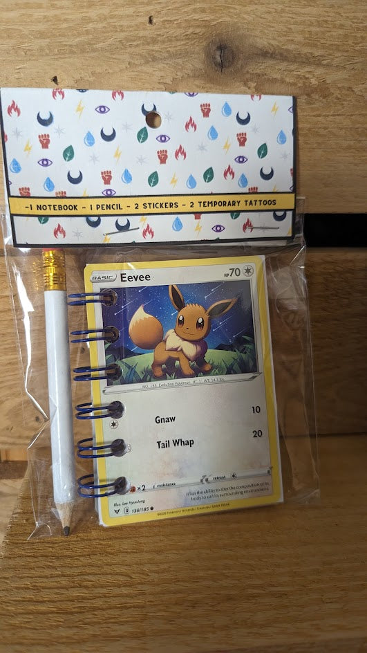 Pokémon card notebooks are packaged with a pencil, two random stickers, and two random temporary tattoos.