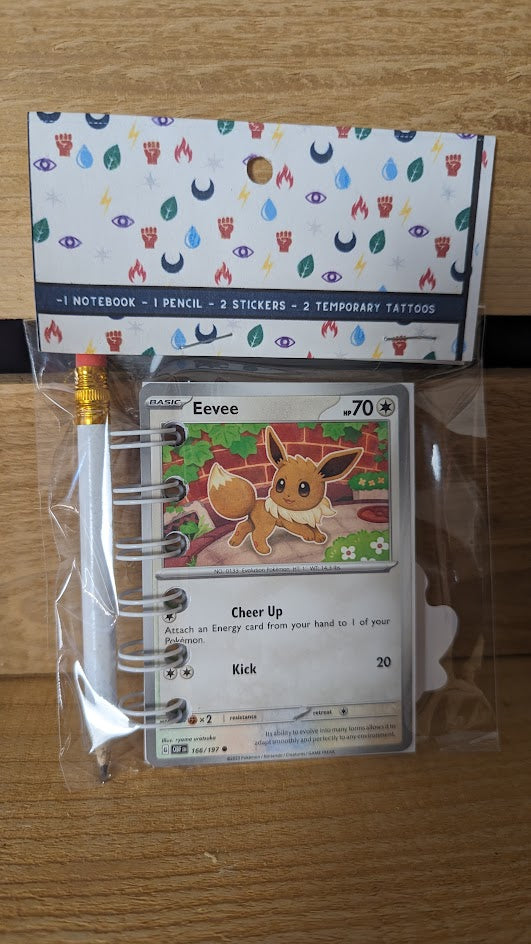 Pokémon card notebooks are packaged with a pencil, two random stickers, and two random temporary tattoos.