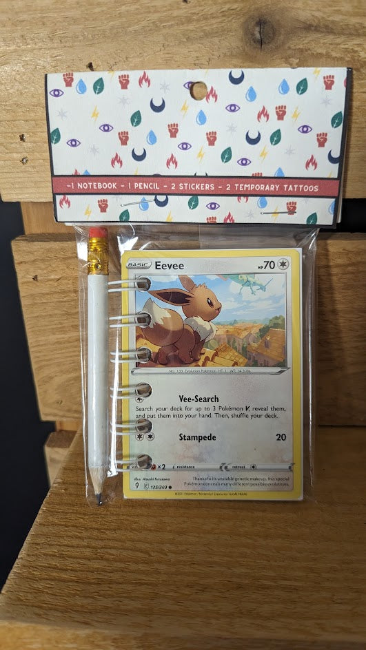 Pokémon card notebooks are packaged with a pencil, two random stickers, and two random temporary tattoos.