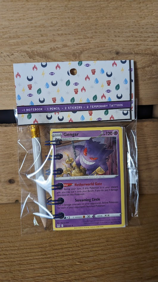 Pokémon card notebooks are packaged with a pencil, two random stickers, and two random temporary tattoos.