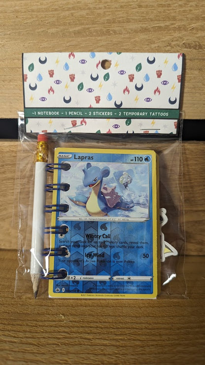 Pokémon card notebooks are packaged with a pencil, two random stickers, and two random temporary tattoos.