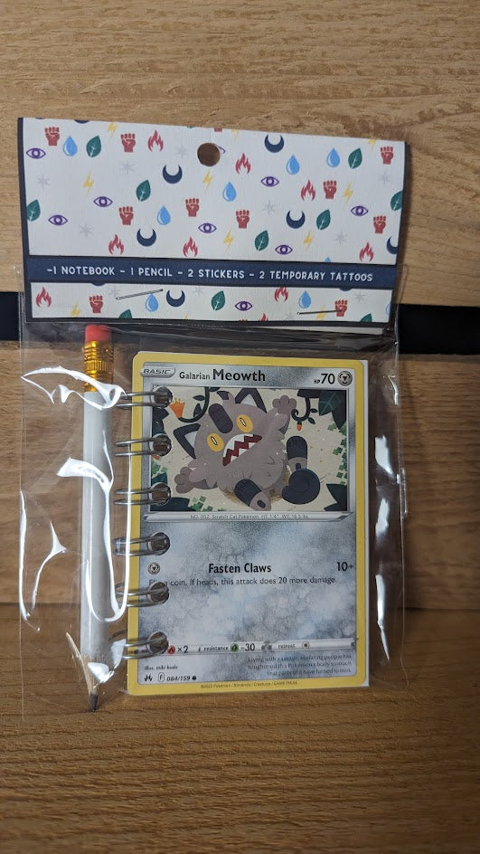 Pokémon card notebooks are packaged with a pencil, two random stickers, and two random temporary tattoos.