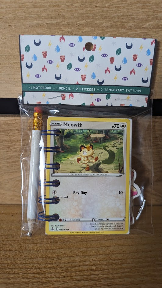 Pokémon card notebooks are packaged with a pencil, two random stickers, and two random temporary tattoos.