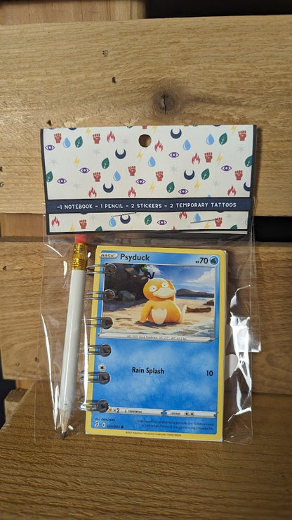 Pokémon card notebooks are packaged with a pencil, two random stickers, and two random temporary tattoos.