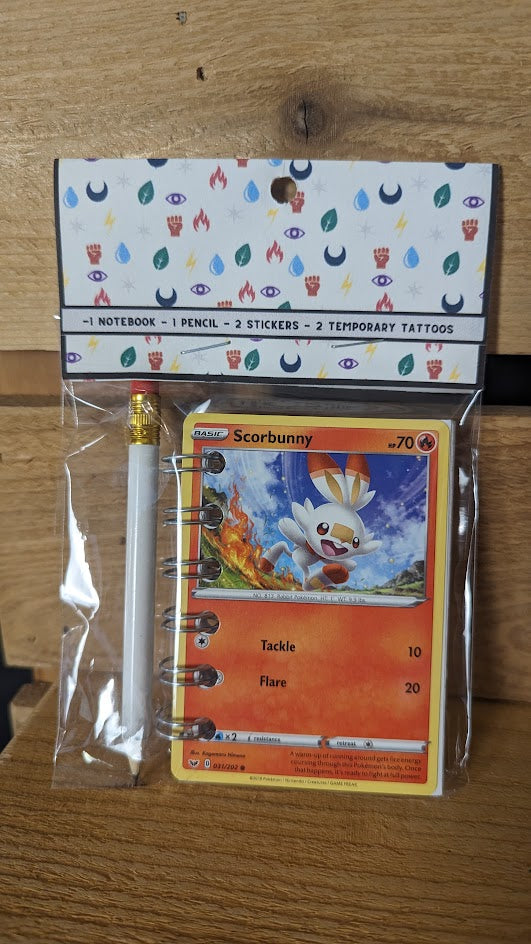 Pokémon card notebooks are packaged with a pencil, two random stickers, and two random temporary tattoos.