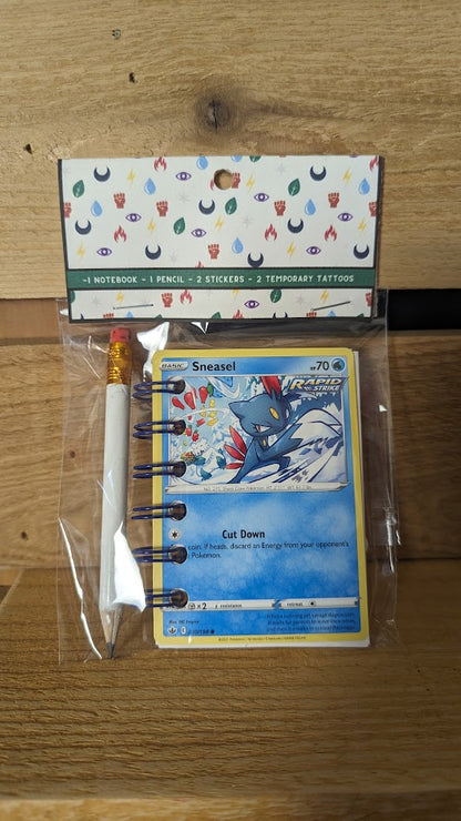 Pokémon card notebooks are packaged with a pencil, two random stickers, and two random temporary tattoos.