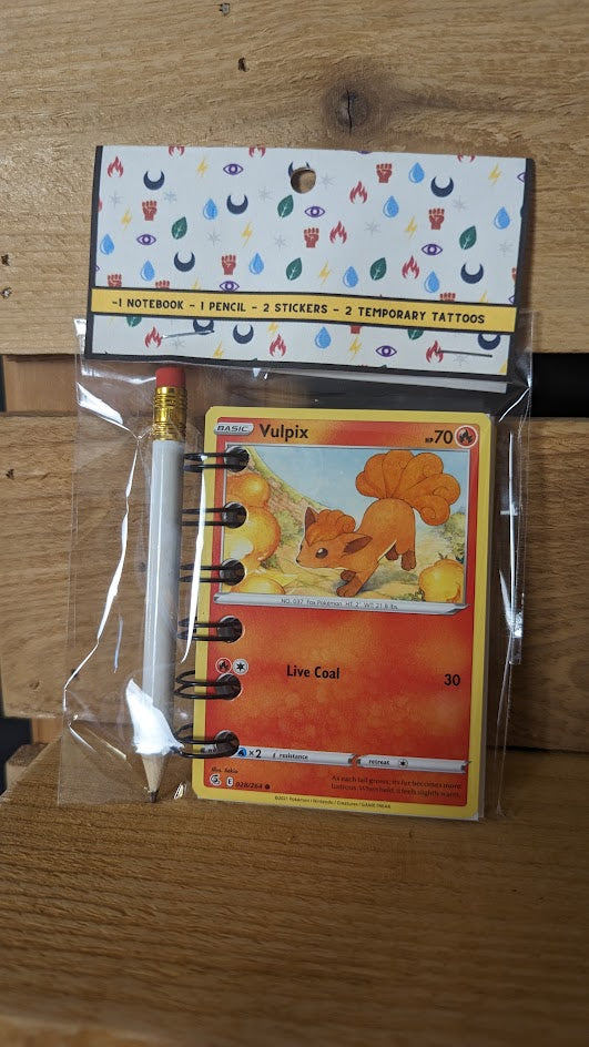 Pokémon card notebooks are packaged with a pencil, two random stickers, and two random temporary tattoos.