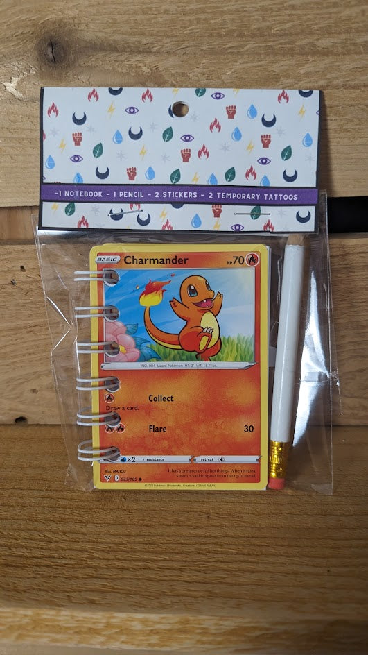 Pokémon card notebooks are packaged with a pencil, two random stickers, and two random temporary tattoos.