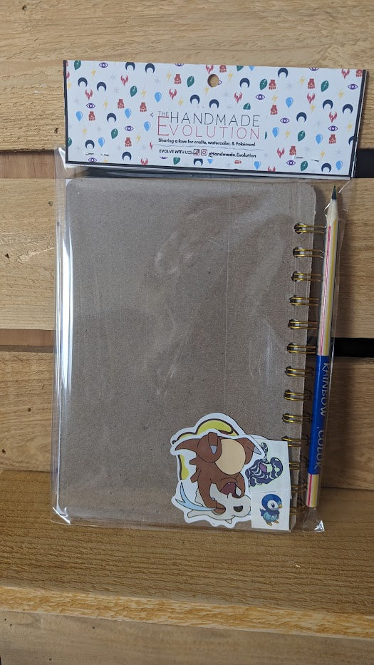 Pokémon card notebooks are packaged with a pencil, two random stickers, and two random temporary tattoos.