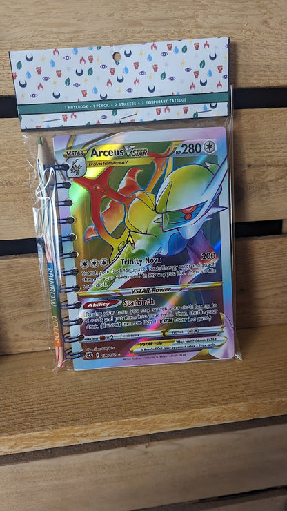 Pokémon card notebooks are packaged with a pencil, two random stickers, and two random temporary tattoos.