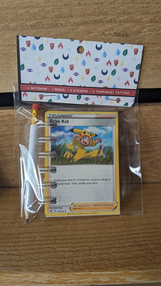 Pokémon card notebooks are packaged with a pencil, two random stickers, and two random temporary tattoos.