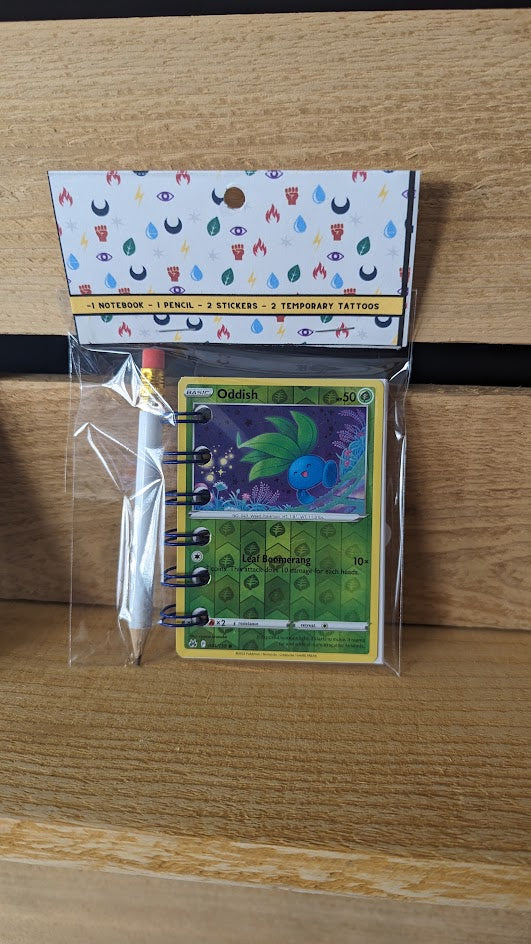 Pokémon card notebooks are packaged with a pencil, two random stickers, and two random temporary tattoos.