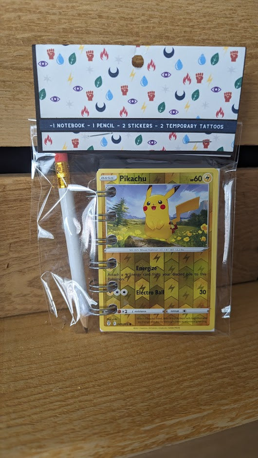 Pokémon card notebooks are packaged with a pencil, two random stickers, and two random temporary tattoos.