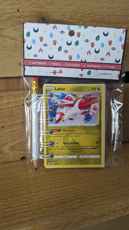 Pokémon card notebooks are packaged with a pencil, two random stickers, and two random temporary tattoos.