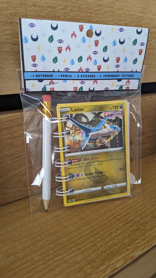 Pokémon card notebooks are packaged with a pencil, two random stickers, and two random temporary tattoos.