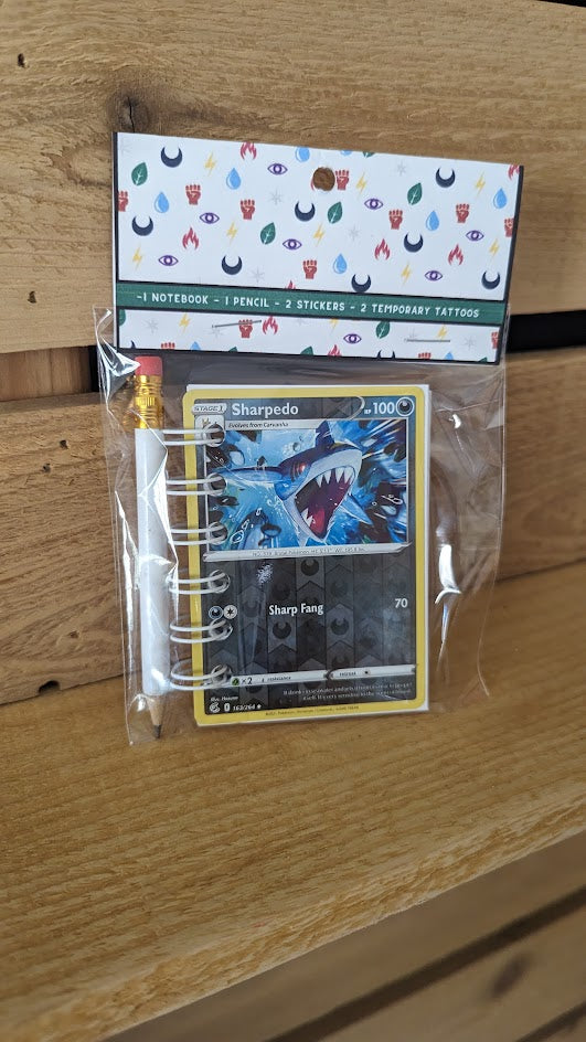 Pokémon card notebooks are packaged with a pencil, two random stickers, and two random temporary tattoos.