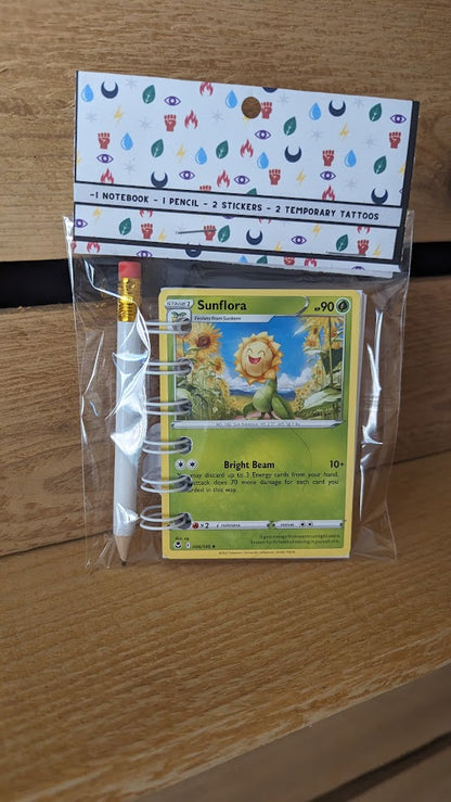 Pokémon card notebooks are packaged with a pencil, two random stickers, and two random temporary tattoos.