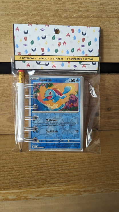 Pokémon card notebooks are packaged with a pencil, two random stickers, and two random temporary tattoos.