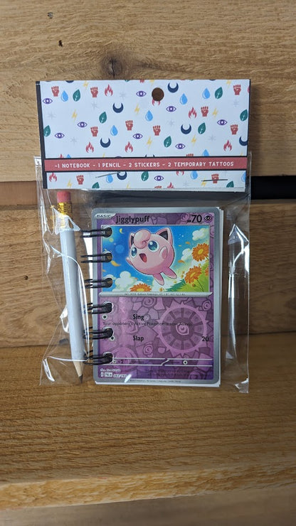 Pokémon card notebooks are packaged with a pencil, two random stickers, and two random temporary tattoos.