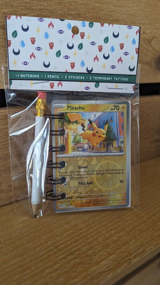 Pokémon card notebooks are packaged with a pencil, two random stickers, and two random temporary tattoos.