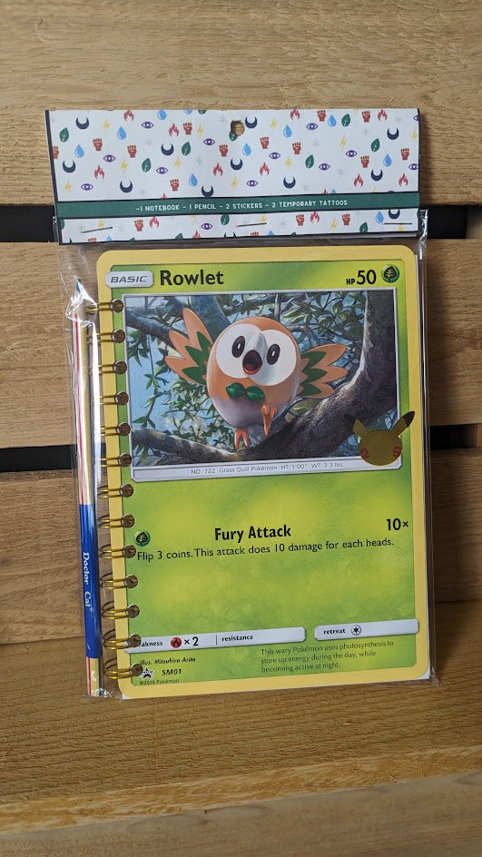 Pokémon card notebooks are packaged with a pencil, two random stickers, and two random temporary tattoos.