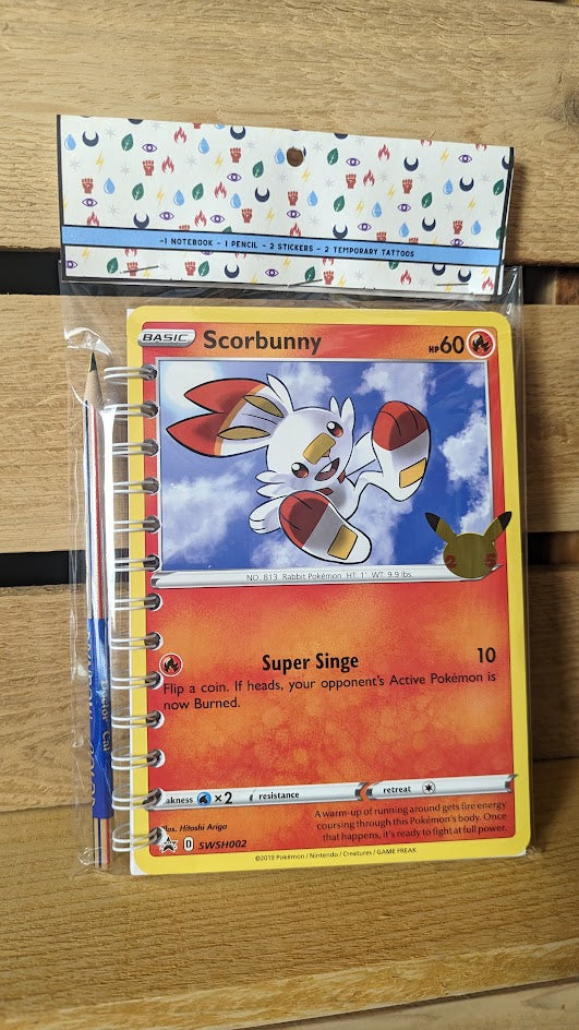 Pokémon card notebooks are packaged with a pencil, two random stickers, and two random temporary tattoos.