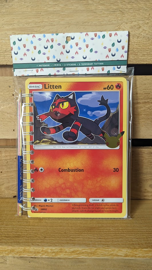 Pokémon card notebooks are packaged with a pencil, two random stickers, and two random temporary tattoos.