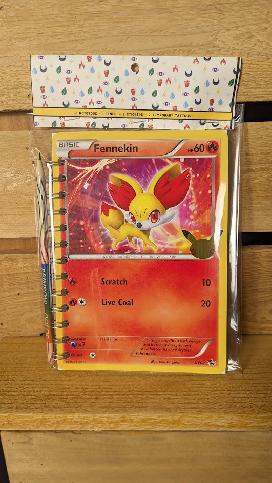 Pokémon card notebooks are packaged with a pencil, two random stickers, and two random temporary tattoos.