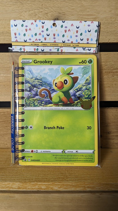 Pokémon card notebooks are packaged with a pencil, two random stickers, and two random temporary tattoos.