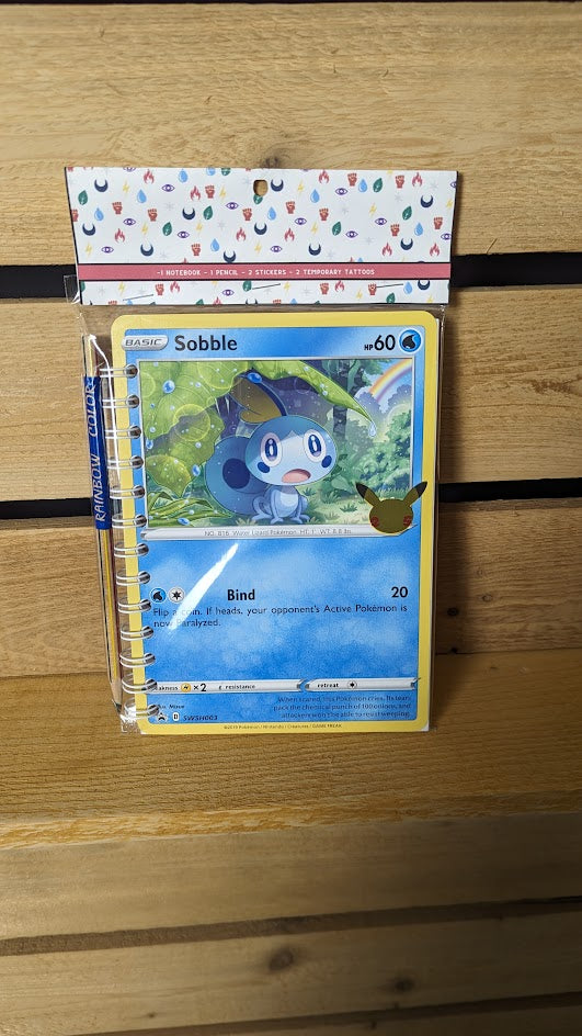 Pokémon card notebooks are packaged with a pencil, two random stickers, and two random temporary tattoos.