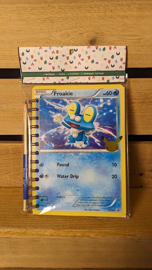 Pokémon card notebooks are packaged with a pencil, two random stickers, and two random temporary tattoos.